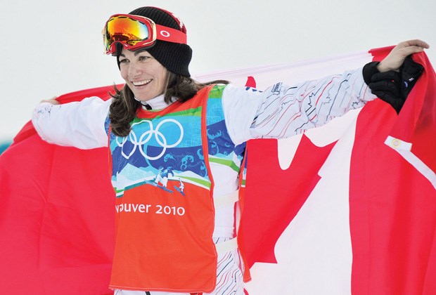 Maëlle Ricker celebrates her Olympic gold medal victory on Cypress Mountain in 2010. A broken arm suffered less than two weeks ago has complicated her plans to defend her title, but the West Vancouver native has vowed to make it into the starting gates in Sochi. File photo