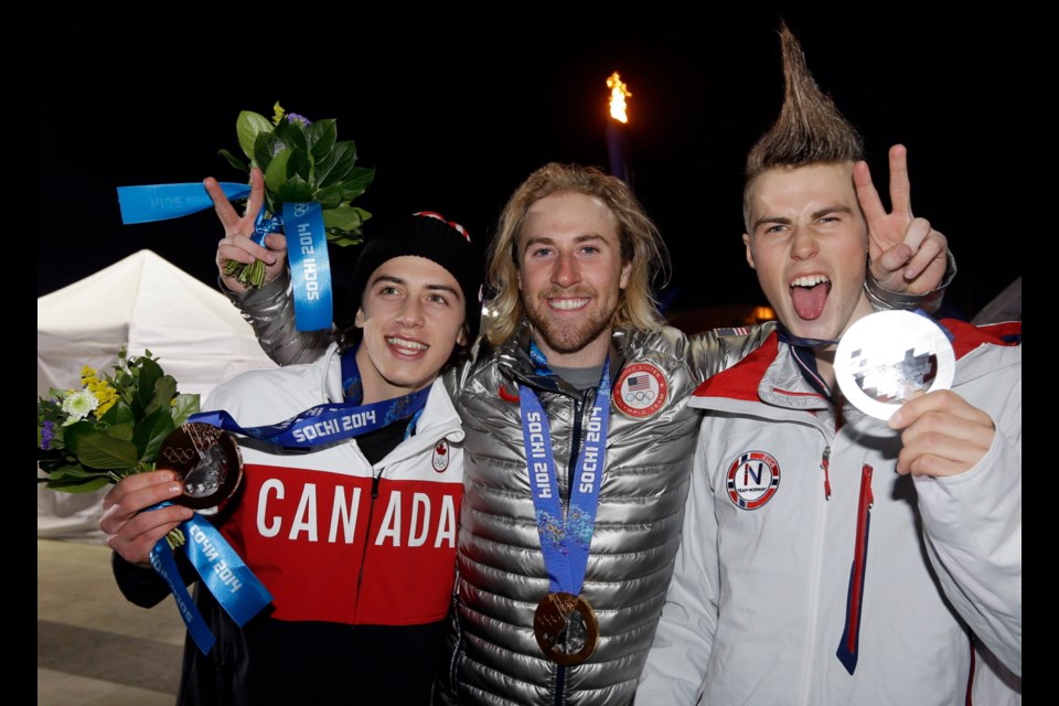 Men's snowboard slopestyle bronze medalist Mark McMorris, left, of Canada, silver medalist Staale Sandbech, right, of Norway and gold medalist Sage Kotsenburg of the United States hold up their medals at the 2014 Winter Olympics, Saturday, in Sochi, Russia.
