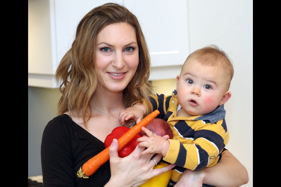 Heather Dueck, a registered dietitian and nutrition consultant with Pacific Institute for Sport Excellence, with her son Gavin, recommends big-batch cooking on Sundays for busy families.