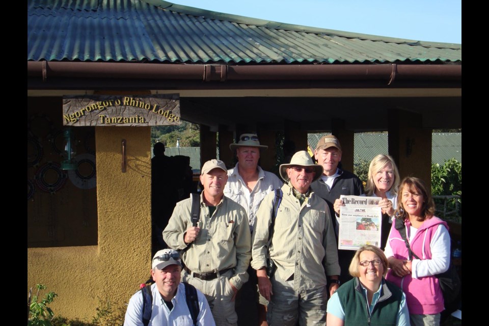 Dan Wilson, Ivan Tuura, Lyle Robinson, Rick Bruce, Steve Manning, Nancy Bruce (seen holding The Record), Margaret Tuura and Nada Wischlow, about to embark on a 12-day African safari in Tanzania and Kenya.