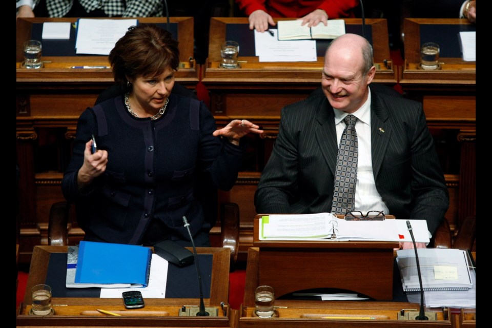 Premier Christy Clark chats with B.C. Finance Minister Mike de Jong before tabling the provincial budget in the Legislative Assembly, Tuesday, February 18, 2014 in Victoria.