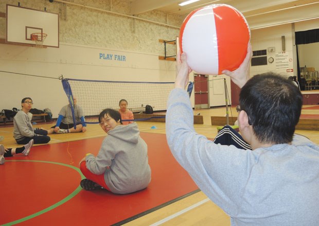 RCD members and volunteers get stuck into a game of seated volleyball at Cook elementary gym. The Monday night open gym session for adapted sports also features speed badminton and 7-a-side soccer.