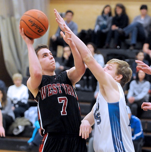 West Vancouver's Carson Batt fends off a Handsworth defender during the Howe Sound AAAA championship final at Sutherland secondary. West Vancouver won on four straight nights, including back-to-back over top-seeded Handsworth, to take the title.