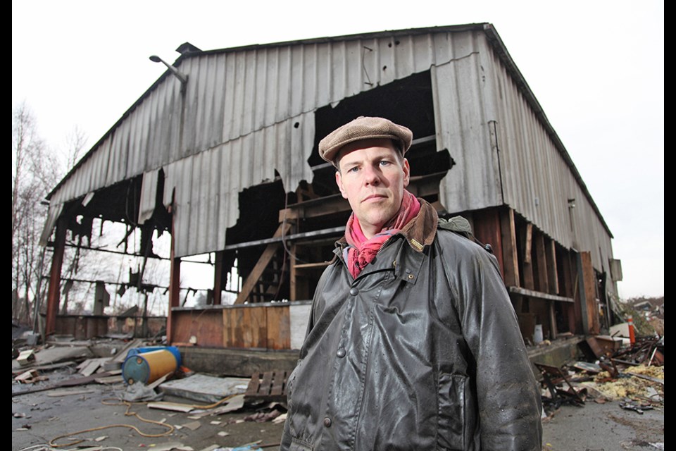 Dumping ground: Riverside resident Shawn Wade at the Globe Foundry, which mostly burnt down in a suspicious fire in January. Since then, more garbage has been piling up on the site, and the neighbours are wondering who will be responsible for the cleanup.