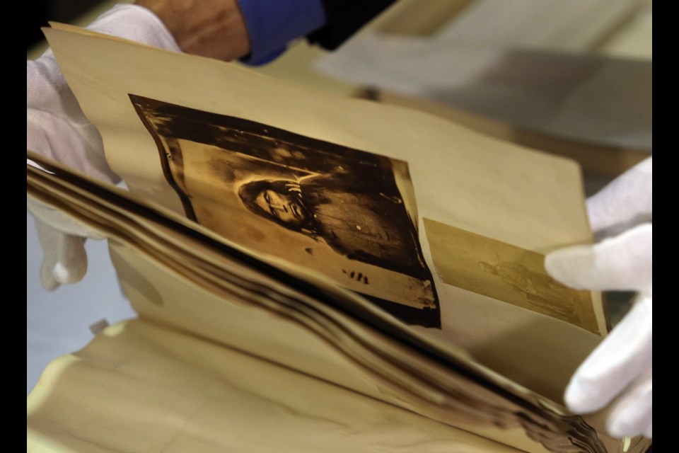 The album acquired by the Royal B.C. Museum was once owned by Col. Richard Moody, chief commissioner of lands and works for the Colony of B.C. from 1858 to 1863. It contains rare images from the province's early colonial days. Moody is seen in one of the photos with an unidentified First Nations man. Museum CEO Jack Lohman presented the album at an unveiling on Tuesday.