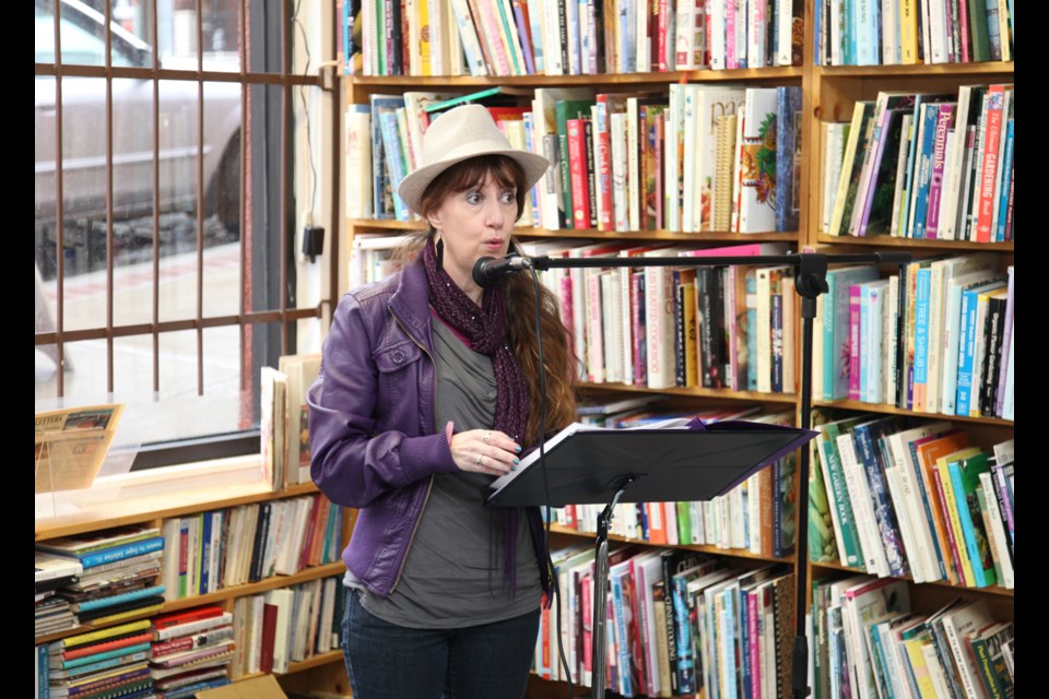 Janet Kvammen reads one of her poems at the Poetic Justice session March 2 at Renaissance Bookstore.