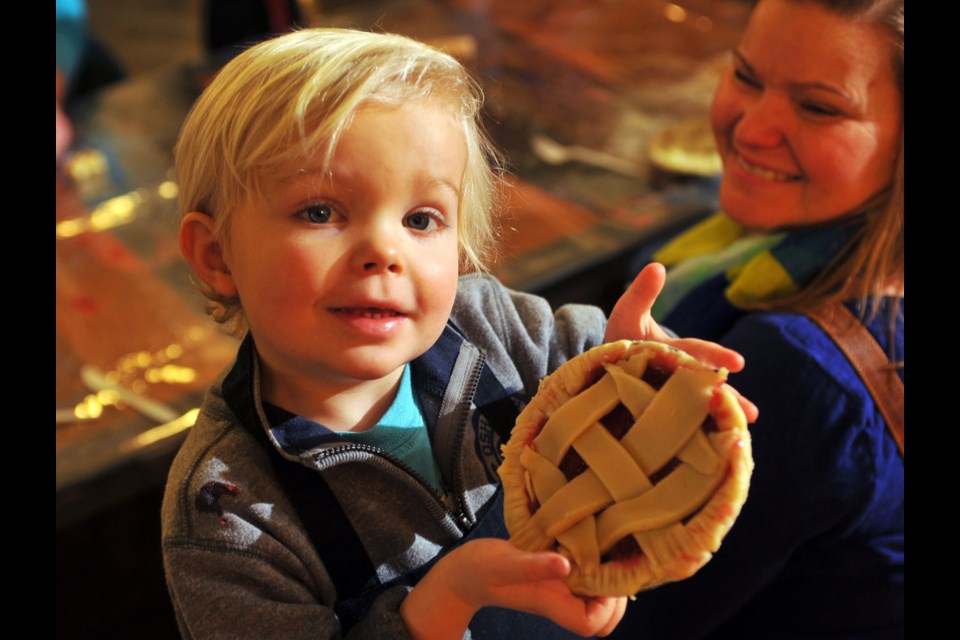 Nicholas Whitta, with mom Nicole, shows off his pie at River Critters baking class at River Market.