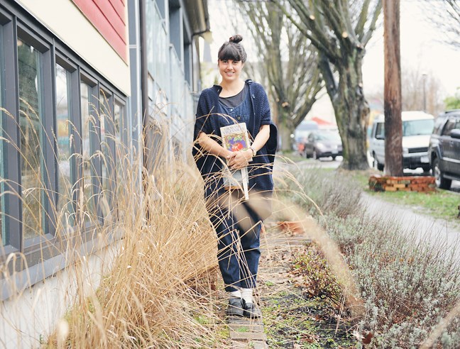 One of the three women behind Victory Gardens is Sam Philips who led Saturday’s workshop on how to start an early garden. Philips is photographed with a gardening book her father gave to her when she was 16 years old. Photo by: Rebecca Blissett