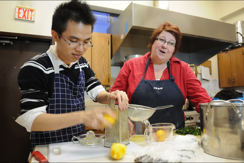 Chef April Pringle and a volunteer prepare Marpole Place’s Thursday night community dinner at St. Augustine’s Anglican Church. Photo: Dan Toulgoet