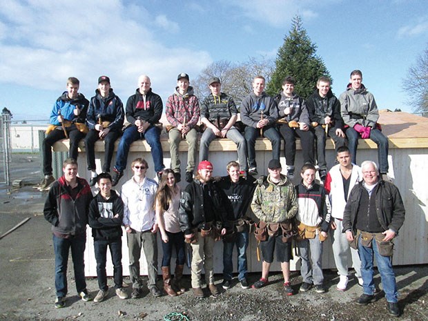 Wayne McKinnon’s carpentry class (pictured) constructed a cabin designed by students in Glen Addison’s drafting class. The cabin will be assembled in 100 Mile House.