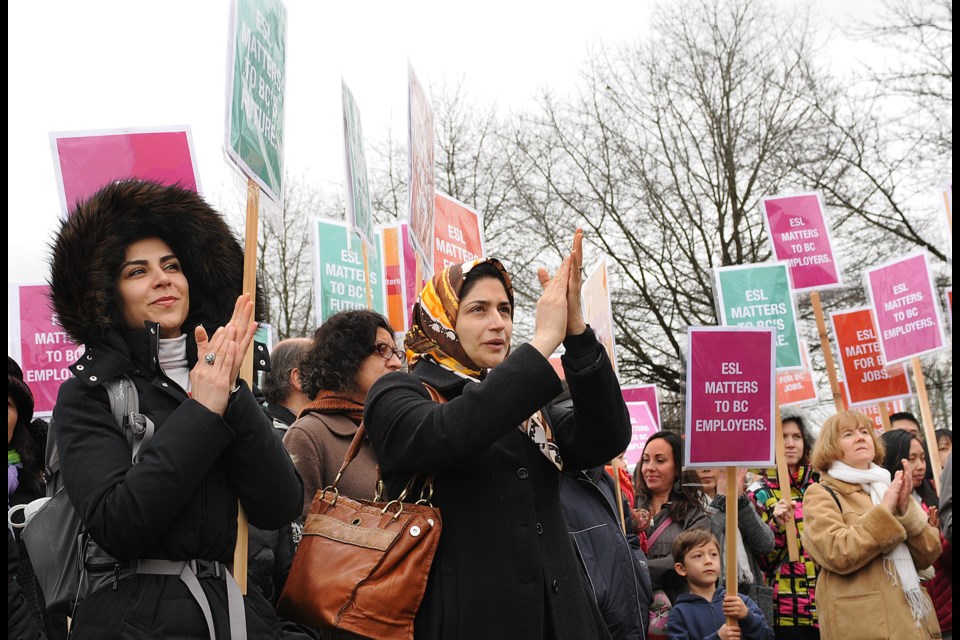 Homa Aghighi (left) and Tayebeh Nasrian (r) took part in a rally at VCC Tuesday calling for the government to restore funding to ESL programs. Photo: Dan Toulgoet