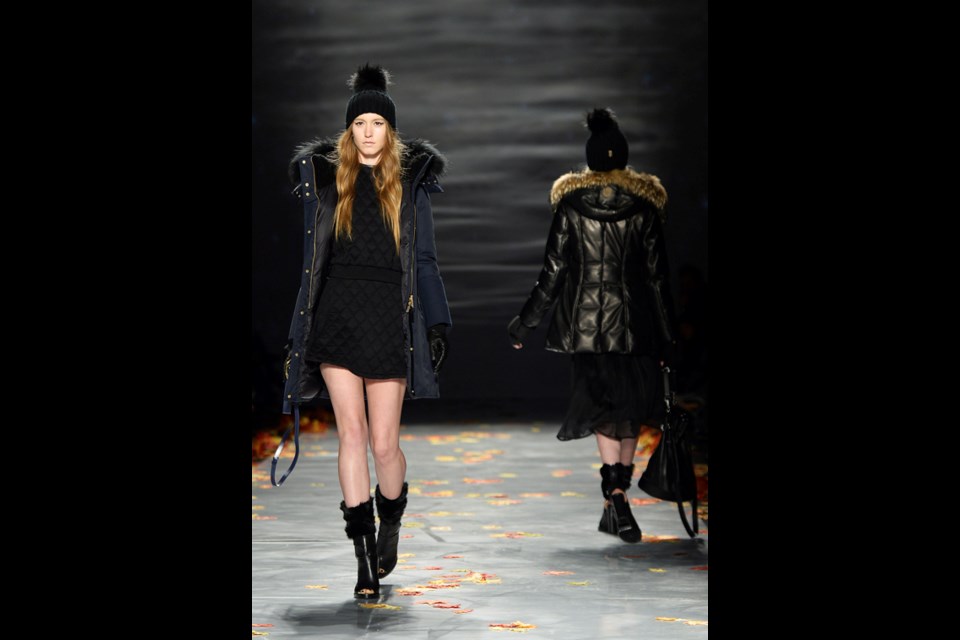 A model shows a creation from Mackage while walking the runway during Toronto Fashion Week in Toronto on Wednesday, March. 19, 2014. THE CANADIAN PRESS/Nathan Denette