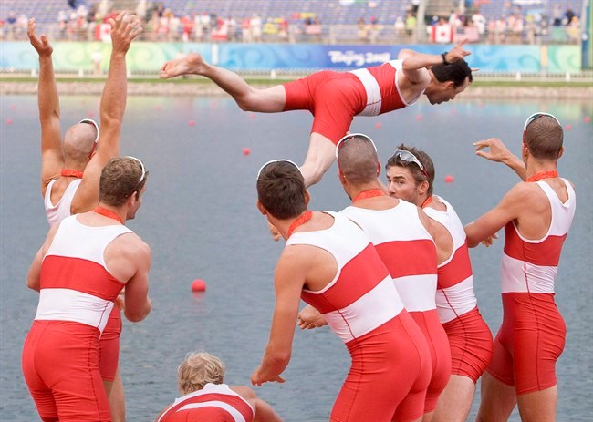 Canada's men's eight team throw coxswain Brian Price into the water following their gold medal win in the men's eight rowing final at the Beijing Olympics in Beijing, China, Sunday, Aug. 17, 2008. THE CANADIAN PRESS/Adrian Wyld