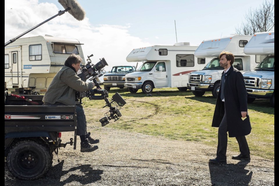 Steadicam operator Richard Wilson prepares to aim his lens at Gracepoint star David Tennant at a set near Island View Beach.