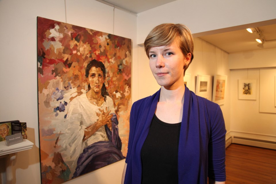 Anouk Jonker with her work at the opening reception for Frames of Reference, currently underway at the Deer Lake Gallery.