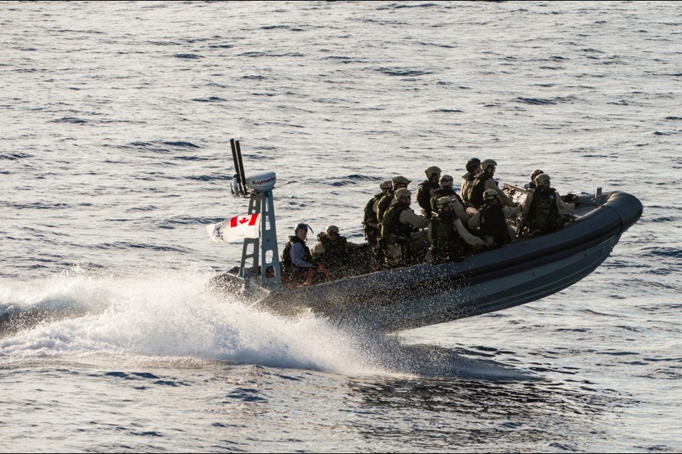 A naval boarding party from Esquimalt-based HMCS Regina approaches a dhow March 25, 2014, during Operation Artemis, a counterterrorism and maritime security patrol off Africa's east coast. (Faces in the image were digitally obscured by the military because of security concerns.)