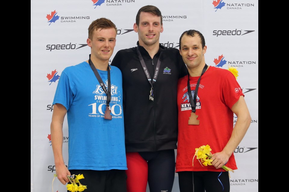Gold medallist Ryan Cochrane, centre, silver medallist Will Brothers, left, and Kier Maitland, right, pose after the medal ceremony during the final day of the Canadian swimming trials at Saanich Commonwealth Place Pool.