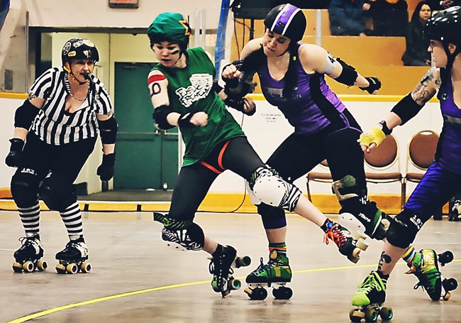 A Faster Pussycats pivot gets her elbow up to knock the Public Frenemy jammer off the track in the opening bout of the Terminal City Rollergirls double-header April 5 at Kerrisdale Arena.