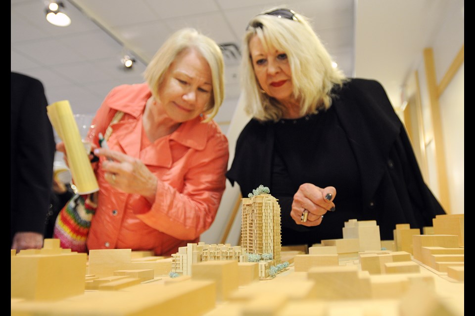 Barbara Jeffery and Marilyn Gardner check out a model for the Rize project at an open house Monday. Photo Dan Toulgoet