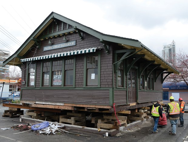 Work crews prepare to lift the historic PGE railway station onto a flatbed truck. The building will sit on the 400-block of Alder Street for the next year while council decides what to do with.