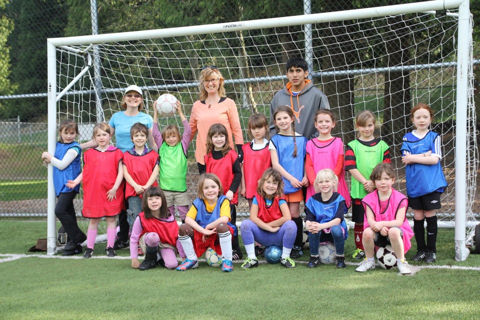Coaches Rina Freed, Merran Smith, Andy Cuba, and fifteen enthusiastic members of the girls soccer league (including one boy, Tyler Matzen).
