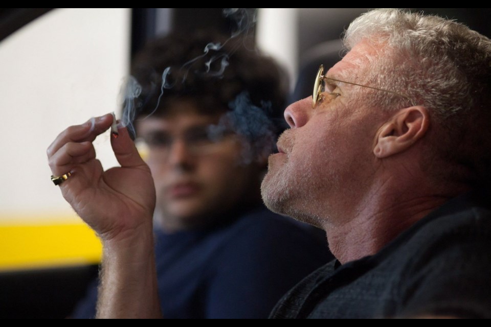 Ron Perlman and Jonathan Daniel Brown share a joint in a scene from Kid Cannabis.
