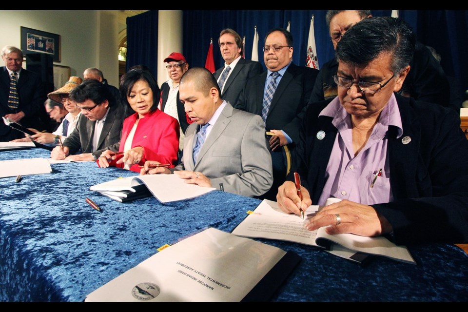 n B.C. Aboriginal Minister Ida Chong signs pre-treaty documents with representatives of five First Nations at the legislature on Tuesday. From left: Songhees councillor Gary Albany, T'Sou-ke Chief Gordon Planes, Scia'new Chief Russell Chipps, Chong, Malahat Chief Michael Harry and Snaw-naw-as Chief David Bob.