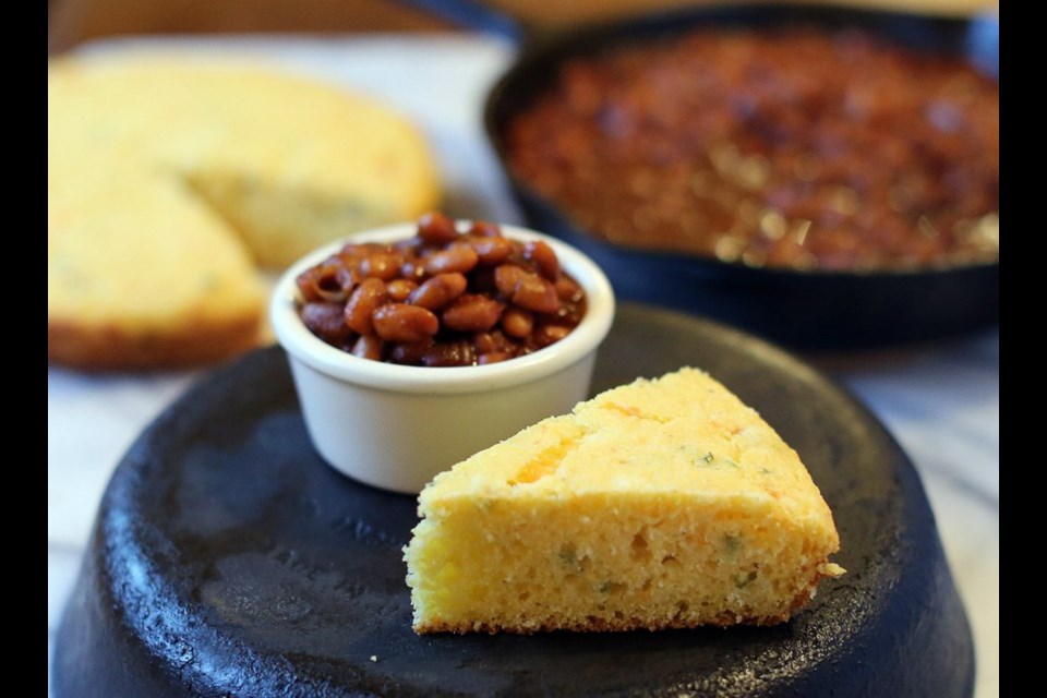 Cornbread, flavoured with cheese and onion, and beans baked with molasses, mustard, ketchup and garlic cloves, are both cooked in cast iron skillets set in the oven.