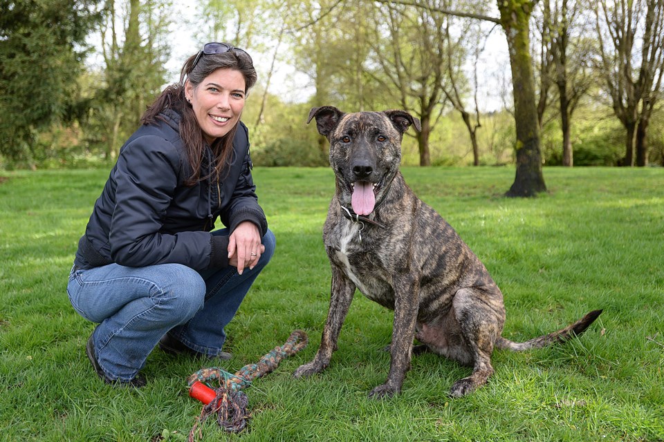 Woman’s Best Friend: Corinne Moore enjoys an outing with Floyd, a three-year-old German shepherd/pit bull cross, at Trout Lake. photo Dan Toulgoet