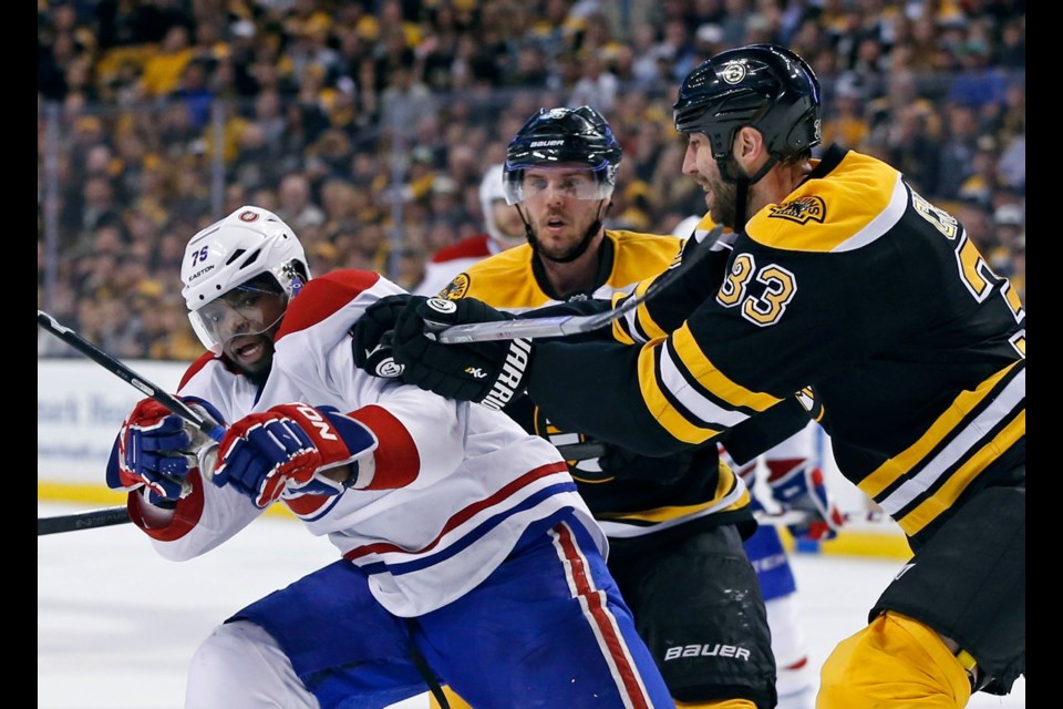 Boston Bruins defenceman Zdeno Chara (33) tries to move Montreal Canadiens defenceman P.K. Subban (76) off the puck as Bruins centre David Krejci, middle, looks on during the second period of Saturday's game.