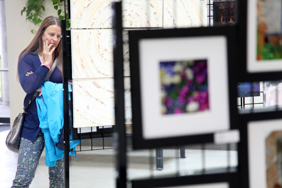 Rosie Moore checks out the Art Squared art show at the River Market.