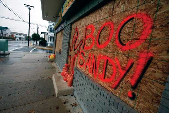 The boarded up windows on a store front in Margate N.J., read "Boo Sandy!", as the area prepares for the arrival of the superstorm, Sunday, Oct. 28, 2012. (AP Photo/Joseph Kaczmarek)