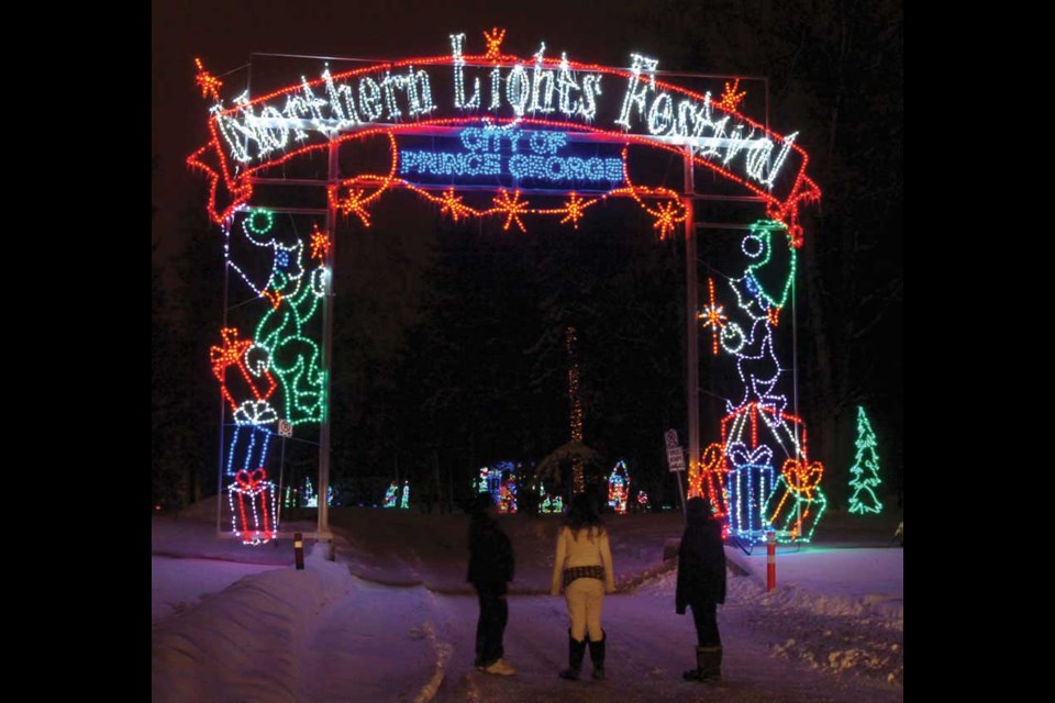 Terry, left, Destiny ,12, and Lateshia, 13, took a close look at the entrance to the Northern Lights Festival on Connaught Hill Saturday night.