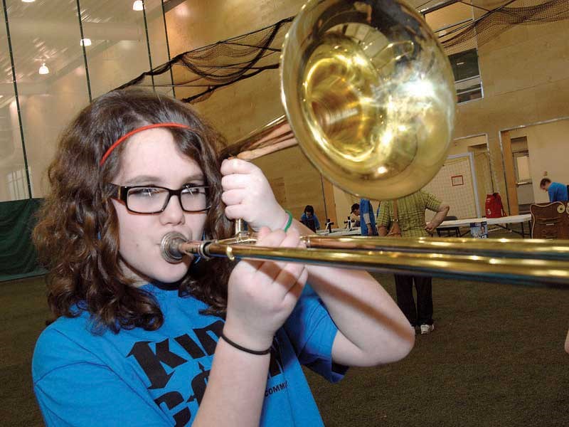Sophia Brewer, 12, a Grade 7 student from Quinson elementary trys a trombone at the Sea Cadets display during Kidd Con-2012 at the Northern sports Centre. Citizen photo by Brent Braaten    Feb 28 2012