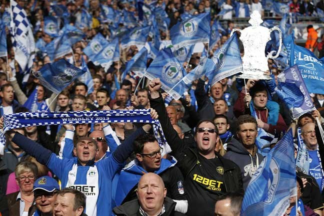 Wigan Athletic's supporters cheer on their team before the start of their English FA Cup final soccer match against Manchester City at Wembley Stadium, London, Saturday, May 11, 2013. (AP Photo/Matt Dunham)