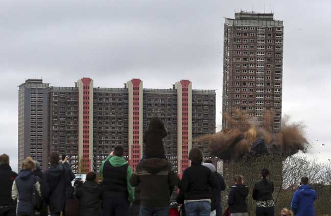 A controlled charge detonates to demolish the iconic landmark Red Road block of flats in Glasgow, Scotland, Sunday May 5, 2013, as former residents and the public look on. (AP Photo / David Cheskin, PA) UNITED KINGDOM OUT - NO SALES - NO ARCHIVES