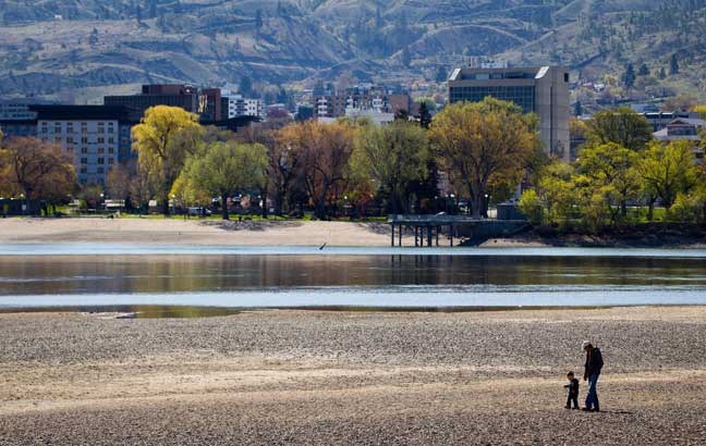 A man and young child walk along the North Thompson River in Kamloops B.C., on Monday April 22, 2013. THE CANADIAN PRESS/Darryl Dyck