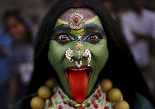 An Indian man dressed as Hindu Goddess Kali participates in a religious procession to mark â??Ram Navamiâ?? festival in New Delhi, India, Friday, April 19, 2013. Ram Navami celebrates the birthday of Hindu god Rama. ( (AP Photo/Kevin Frayer)