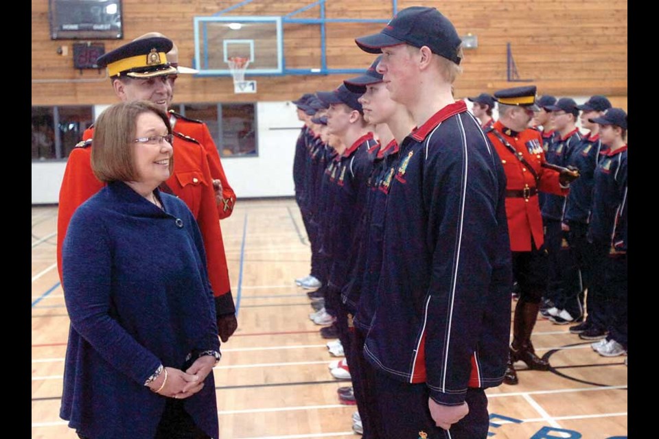 Minister of Justice Attorney General Shirley Bond, RCMP Supt. Eric Stubbs, and Staff Sgt. Doug Pack, inspect the 26 cadets of Troup 11.