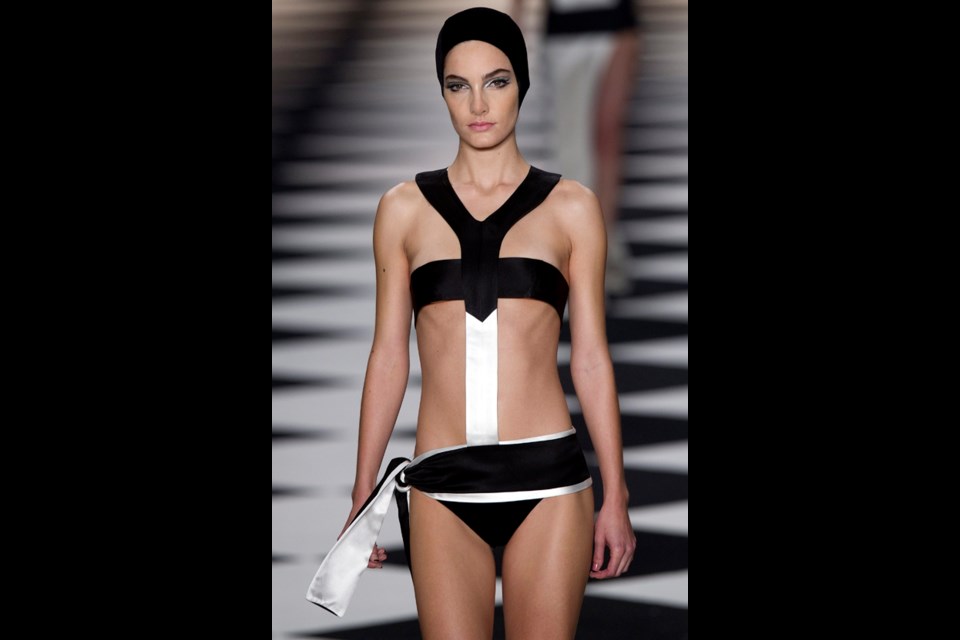 A model wears a creation from the Adriana Degreas summer collection during Sao Paulo Fashion Week in Sao Paulo, Brazil, Tuesday, March 19, 2013. (AP Photo/Andre Penner)
