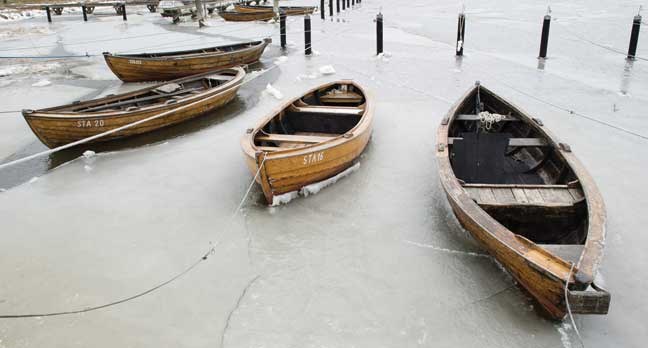 Fisher boats are enclosed in the ice in the harbor of Stahlbrode at the Baltic Sea in northeastern Germany, Monday, March 18, 2013. Meteorologists predict the unusual cold and snowy weather to continue in northeastern Germany. (AP Photo/dpa, Stefan Sauer)