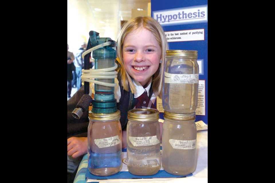 Brooke Svendsen, 10, from Immaculate Conception elementary, shows her water samples at her Purifying Water in the Wilderness booth at the annual Central Interior Science Exhibition. 118 projects were on display, put together by 159 students. Brooke's samples show filtered water, the bottom left, is clearer than boiled water.