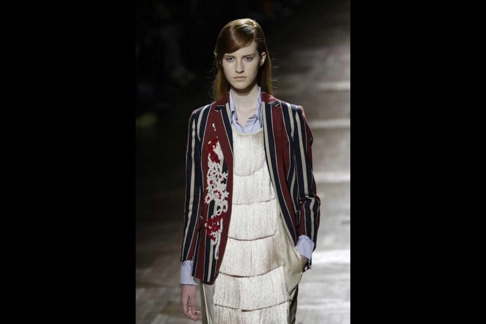 A model presents a creation for Belgian fashion designer Dries van Noten's Ready to Wear's Fall-Winter 2013-2014 fashion collection, presented, Wednesday Feb.27, 2013 in Paris. (AP Photo/Christophe Ena)