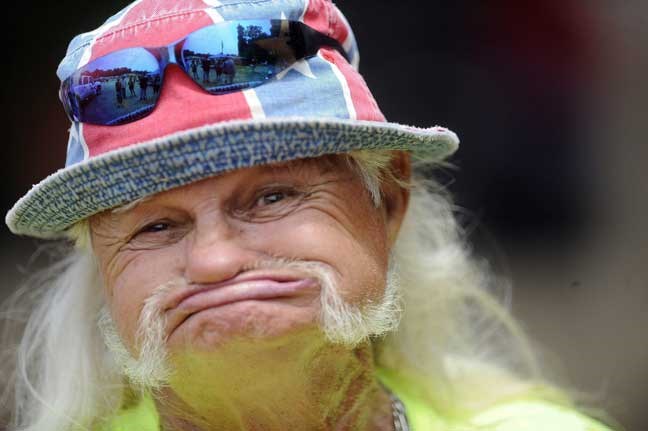 In this Saturday, July 9, 2011 photo, Redneck Games emcee Freight Train Mills walks to the stage at the at the 15th annual Redneck Games in East Dublin. Ga. After lackluster attendance at the 2012 games, organizers have decided to cancel this year's event and take a year off, with the idea of restarting the event in 2014, said Larry Drew, the city administrator. (AP Photo/Mike Stewart)