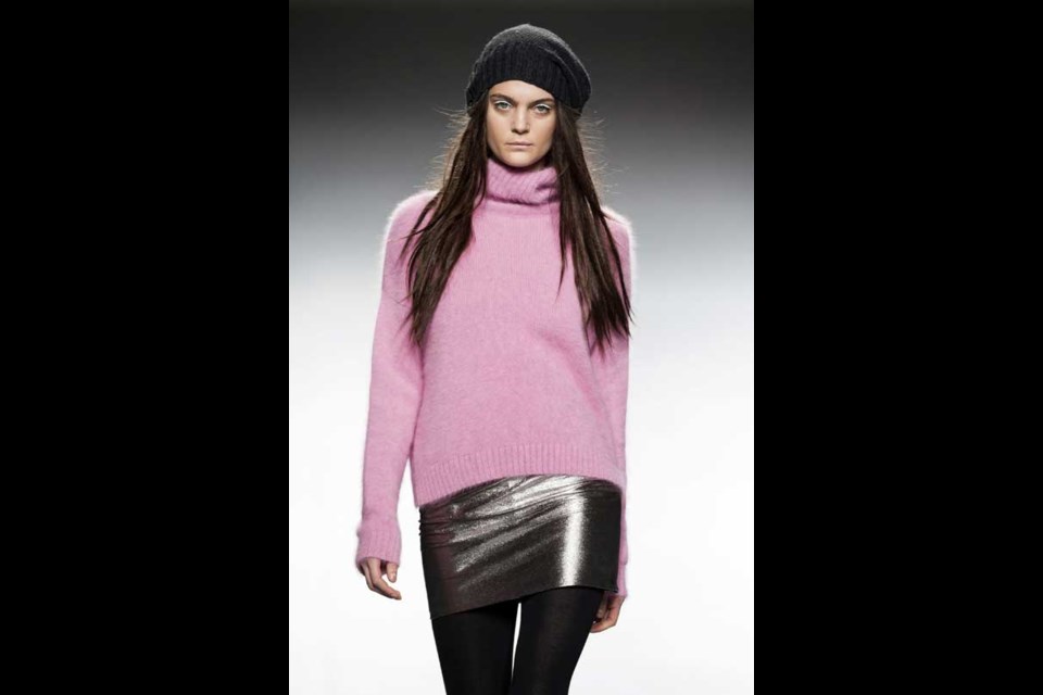 A model displays an Autumn/Winter design by TCN during Madrid's Fashion Week, in Madrid, Thursday, Feb. 21, 2013. (AP Photo/Daniel Ochoa De Olza)
