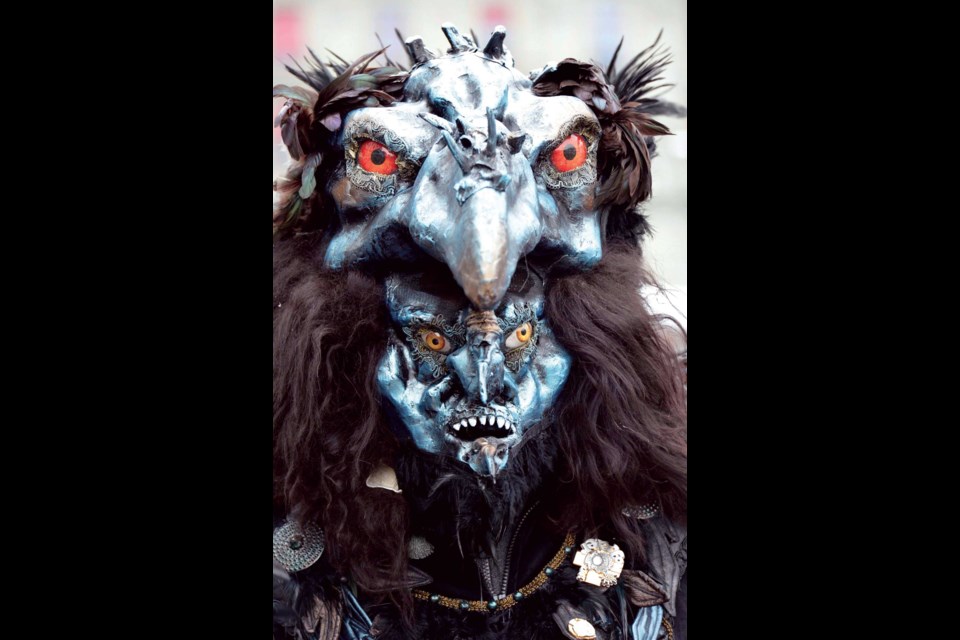 A disguised reveler takes part in the carnival parade in the historic center of Lucerne, Switzerland, Thursday, Feb. 7, 2013. (AP Photo/Keystone,Urs Flueeler)