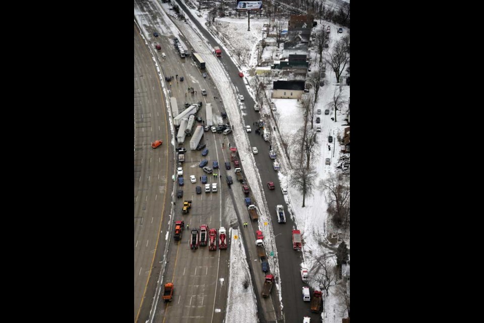 Emergency personnel respond at the scene of one of a mile-long series of crashes along Interstate 75 near the Springwells exit on the southwest side of Detroit Thursday, Jan. 31, 2013. At least three people are dead, including two children, and 20 more were injured in the pileups. (AP Photo/Detroit Free Press, Romain Blanquart) DETROIT NEWS OUT; NO SALES