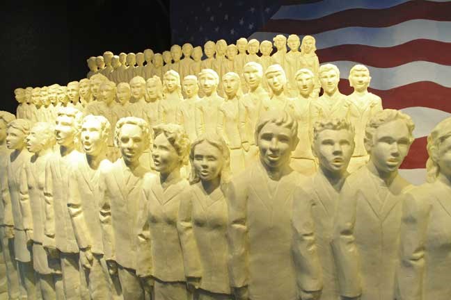 This undated photo provided by the American Dairy Association shows the All-Ohio State Fair youth choir as part of the 2013 butter sculpture display at the Ohio State Fair in Columbus, Ohio. The display for this year's edition of the fair celebrates the 50th anniversary of the All-Ohio Youth Choir and pays tribute to its founder, Glenville D. Davis. (AP Photo/American Dairy Association)