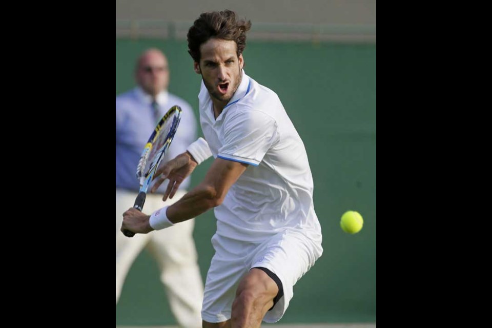 Feliciano Lopez of Spain plays a return to Gilles Simon of France during their Men's first round singles match at the All England Lawn Tennis Championships in Wimbledon, London, Tuesday, June 25, 2013. (AP Photo/Alastair Grant)