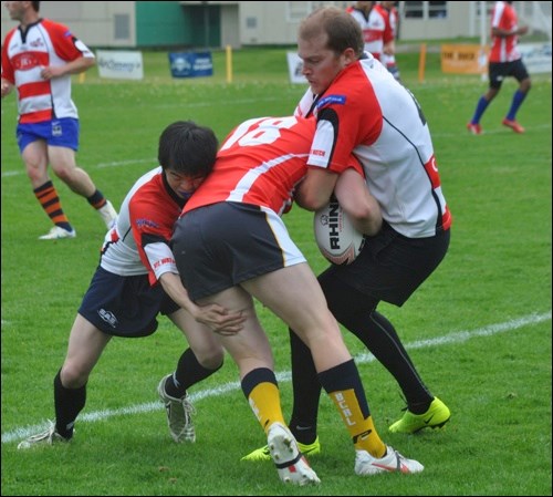 Two members of the Sea to Sky Eagles team up to take down a member of the Vancouver Dragons.